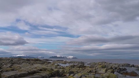 Rocky shoreline in Norway. Runde in background