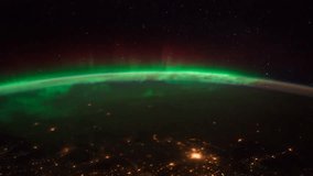Outer space Earth view from the ISS as it passes above Dakota Quebec at night with the Aurora Borealis visible. Elements of this image furnished by NASA on Jan 26, 2012. Tilt Down Motion Time lapse.