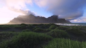 Amazing view of unique sand hills, sunny day. Location Stokksnes cape, Vestrahorn (Batman), Iceland, Europe. Time lapse clip. Beautiful nature landscape. Discover the beauty of earth. HD 1080 video.