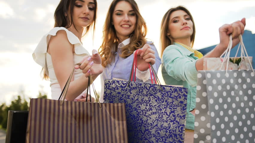 Three stylish women shows shopping bags Royalty-Free Stock Footage #1009054016