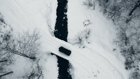 Aerial top down view of a car crossing a river bridge during winter season  - Powered by Shutterstock - Get 15% off with code: PIKWIZARD15