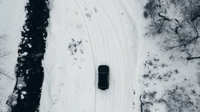 Aerial top down view of a car crossing a river bridge during winter season  - Powered by Shutterstock - Get 15% off with code: PIKWIZARD15