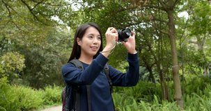 Young woman taking video with camera at outdoor