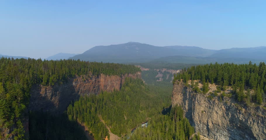Aerial of beautiful cliff and forest on a sunny day 4k