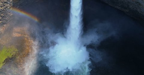 Aerial of beautiful waterfall and rainbow on a sunny day 4k