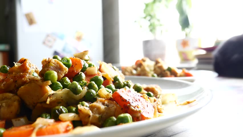 Home made food from fried vegetables on a plate. Soy and green peas, vegetarian dishes. | Shutterstock HD Video #1009076000