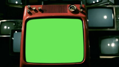 A Vintage Red Television with Green Screen over Many Retro TVs from the 80s and 90s. Dolly Shot. You can Replace Green Screen with the Footage or Picture you Want with “Keying” effect in AE.