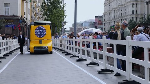 MOSCOW - SEP 10, 2017: Unmanned bus drives by Tverskya street with lot of people during City Day holiday