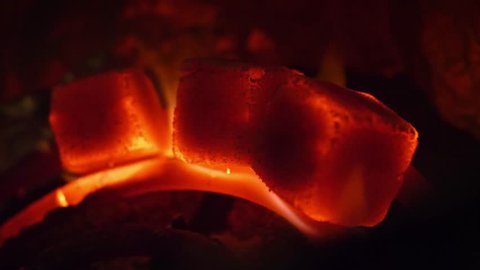Hot coals in the hookah bowl in darkness closeup in 4k in slow motion