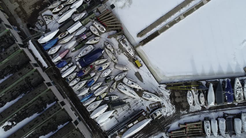 Yachts in winter parking. Yachts on the pier. 