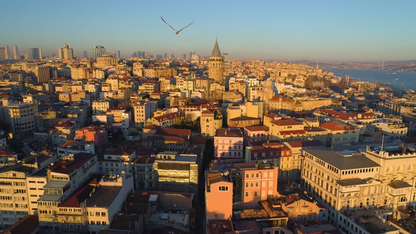 Galata tower in Istanbul, Turkie. Aerial drone shot from above, city centre, downtown. European part of the city. Sunny day, sunset. | Shutterstock HD Video #1009113494