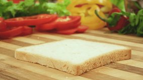 Stop motion video of making sandwich with tomato, ham, bow, cheese and salad