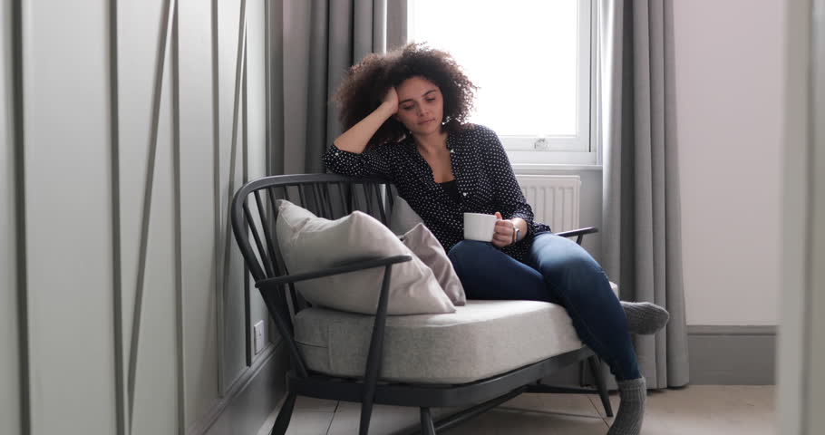 Portrait young adult female relaxing at home with coffee | Shutterstock HD Video #1009115942