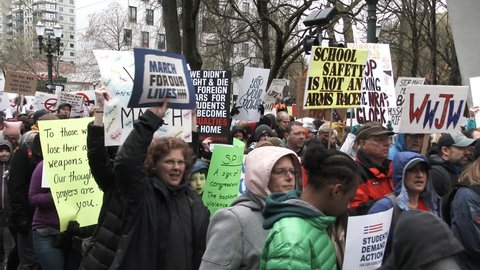 PORTLAND, OREGON / USA - MARCH 24, 2018: People protesting with signs downtown chanting "No more NRA!" march for awareness to Congress to pass strict gun laws.