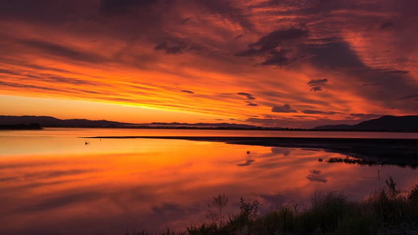 Timelapse of red sky sunrise over the lake