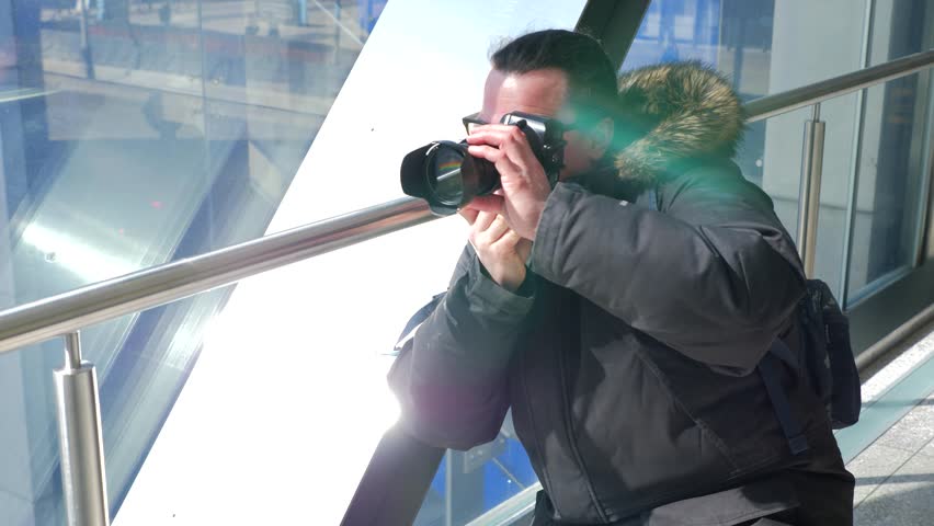 Photographer taking a photo in a walkway over pass in downtown 1