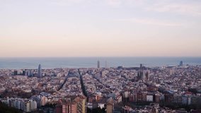 A time lapse of Barcelona, Spain. It is sunset time and the sun is almost gone. The Mediterranean sea is at the back. The view is taken from the antiaircraft refugee.