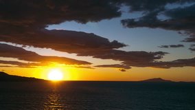 Time lapse of sea sunset with stormy clouds over the ocean on the mountains rock beach, Sorrento Italy Amalfi. Dramatic cloudy sky. meditation, relax concept, ships and boats