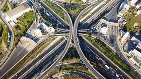 Aerial drone bird's eye view video of highway multilevel junction road, passing through city center