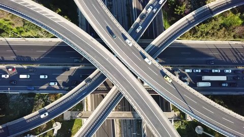 Aerial drone bird's eye view video of highway multilevel junction road, passing through city center