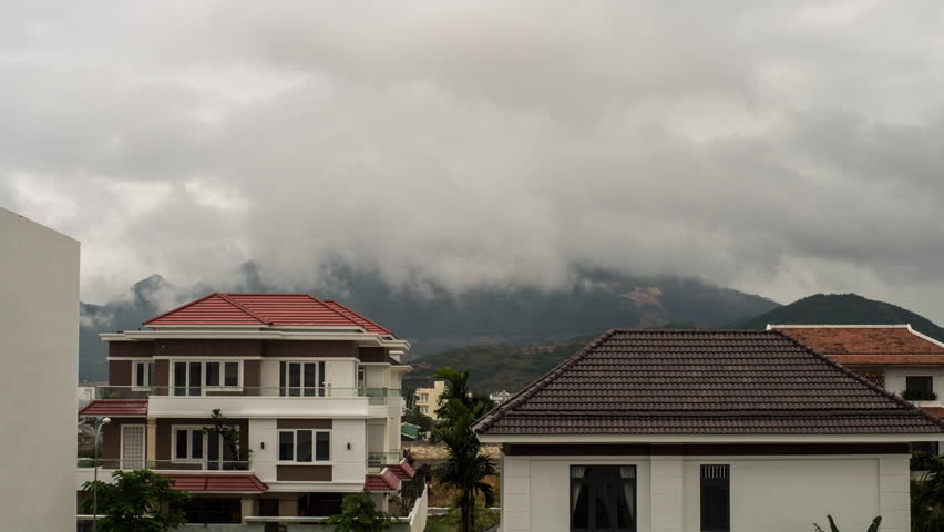 Time lapse of fog rolling in over the hills and rooftops cloudy weather