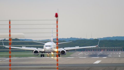 DUSSELDORF, GERMANY - JULY 22, 2017: SunExpress Boeing 737 TC-SEK braking after landing. Dusseldorf Airport, Germany