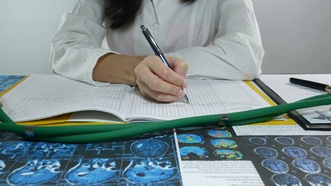 Doctors study skull brain X-ray film for analysis.