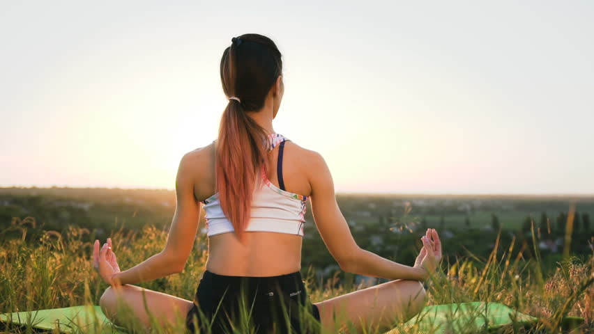 Slender girl doing yoga in the field at sunset. Outdoor healthcare. Wide shot
 Royalty-Free Stock Footage #1009197059