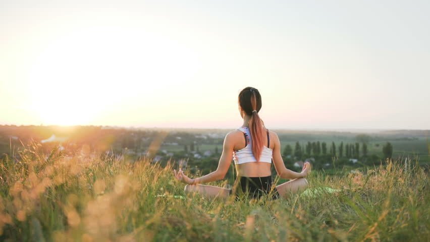 Slender girl doing yoga in the field at sunset. Outdoor healthcare. Wide shot
 Royalty-Free Stock Footage #1009197062