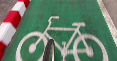 Cyclist cycling on the green road for exercise and good healthy. Bicycle green lane for cyclists.
