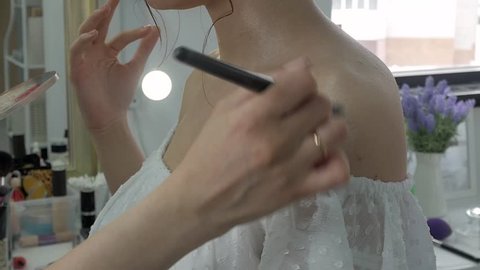 Young beautiful woman applying make-up by make-up artist 4k