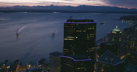 Cinematic Seattle Night Waterfront View Skyscraper Towers Ferry Ships Puget Sound Purple Sun Reflection Olympic Mountain Peaks Horizon Pacific Northwest Establishing Shot Slow Motion