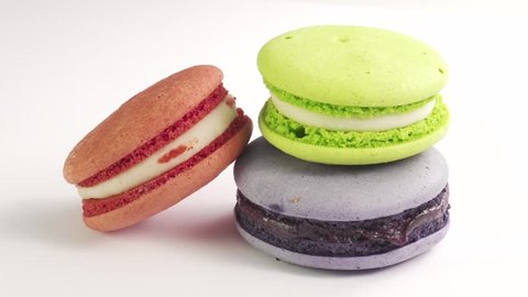 Three colorful French Macarons on the white background.