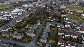 Aerial drone footage of suburban houses and countryside in UK