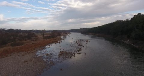 flight from edge of Brazos in the morning with nice view up stream of the river and clouds in the skyline. Video de stock