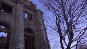 Destroyed church next to a dry tree. Video full hd.