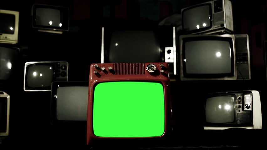 A Retro Red TV with Green Screen Around Many Retro TVs. Dolly Shot. Contrasted Tone. You can replace green screen with the footage or picture you want with “Keying” effect in After Effects.  Royalty-Free Stock Footage #1009220405