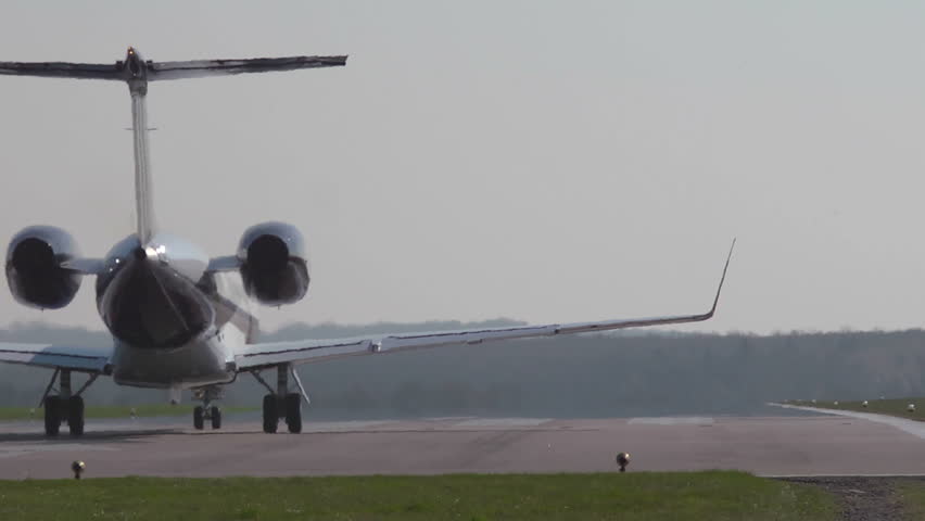 Executive jet Taking off from behind at Oxford Airport. This airfield is used extensively for business and private avaiation.