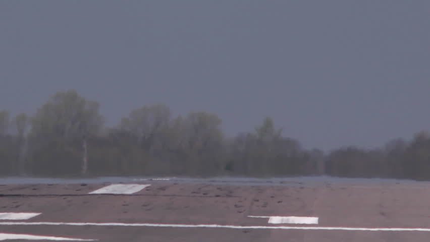 A light single engined aircraft comes in to land on the runway at Oxford Airport.