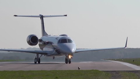 Executive jet taxiiing onto the runway at Oxford Airport. This airfield is used extensively for business and private avaiation.