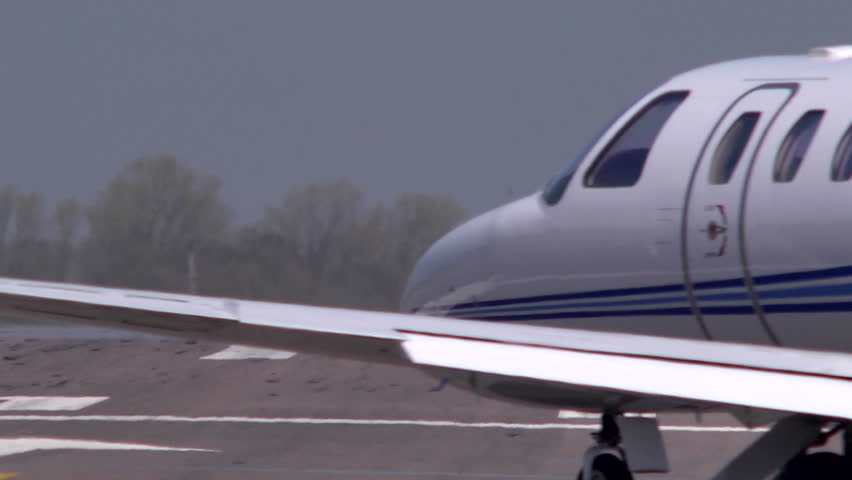 Executive jet taxiiing onto the runway at Oxford Airport. This airfield is used extensively for business and private avaiation.