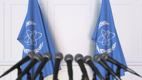 International Atomic Energy Agency IAEA official press conference. Flags and microphones. Conceptual editorial 3D animation
