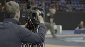 Cameraman with a camera while shooting sports. Media, news, press, TV (man, male)
