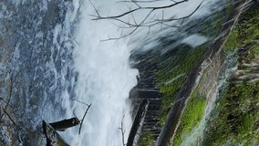 Vertical video. Waterfall flows from Yusupov lake. Mountain Crimea