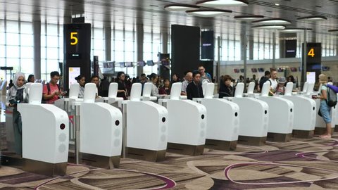 Passengers Passing Through Customs Control With Immigration Automated Clearance System In Airport.