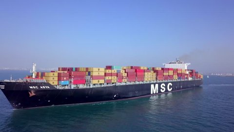 Mediterranean sea - March 28, 2018: Aerial footage of M.S.C Asya mega container ship at sea, loaded with various container brands 