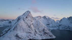 4k Aerial drone footage - Winter sunrise over the beautiful mountains of Reine, Norway.  Lofoten Islands archipelago.