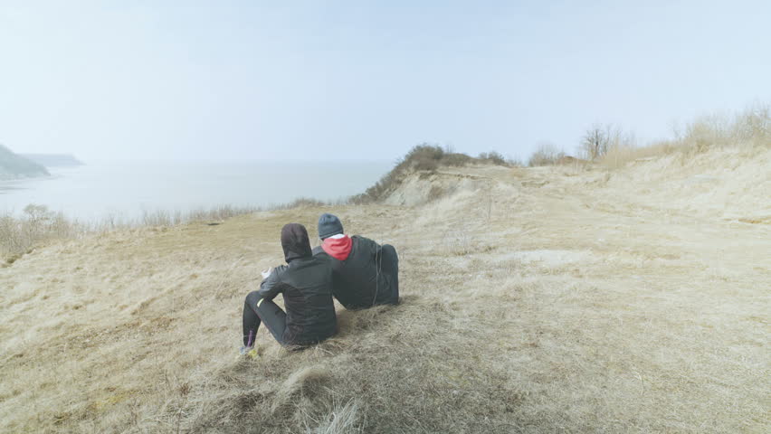 A young couple ran from a beautiful sea bay. 4K