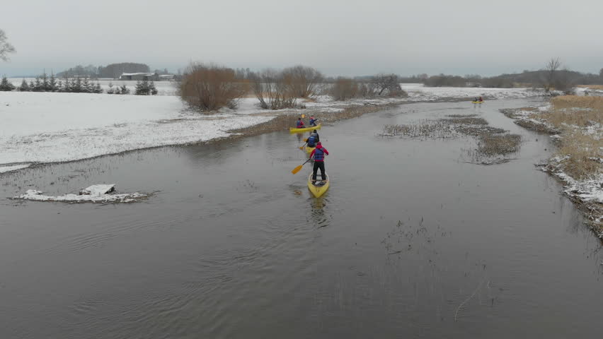 Aerial drone tracking shot of kayaks paddling
