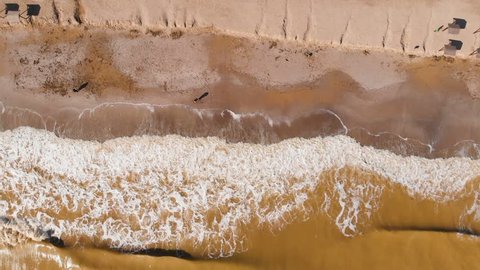 Aerial view of clay-polluted sea coast. Muddy sea water. Environmental contamination. Chemical accident. Video shot with a drone.